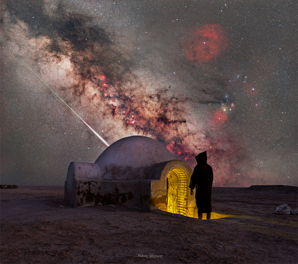 A starry sky is seen above a structure with an iconic
dome. A person in shadow stands at the entrance. Sloping down 
in the sky is the central band of our Milky Way Galaxy. Just 
below the Milky Way is the streak of a bright meteor. 
Please see the explanation for more detailed information.